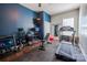 Well-equipped exercise room with a treadmill, weight bench, and blue accent wall, promoting wellness at 15125 Skypark Dr, Huntersville, NC 28078