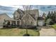 Charming two-story home with a welcoming front porch and well-manicured landscaping at 15125 Skypark Dr, Huntersville, NC 28078