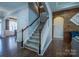 Inviting foyer with hardwood floors, staircase, and entry to living spaces, offering a warm welcome at 15125 Skypark Dr, Huntersville, NC 28078