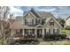 Beautiful home featuring a cozy front porch, well-maintained landscaping, and classic architectural details at 15125 Skypark Dr, Huntersville, NC 28078