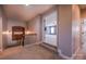 Upstairs hallway with carpet and grey walls; an open door shows an adjacent bedroom with blue walls at 15125 Skypark Dr, Huntersville, NC 28078