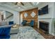 Cozy living room with a fireplace, hardwood accent wall, plush seating, and a seamless flow at 15125 Skypark Dr, Huntersville, NC 28078
