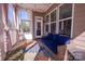 Screened-in porch with comfortable blue seating, bright rug, and view of backyard at 15125 Skypark Dr, Huntersville, NC 28078