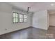 Bright bedroom with three black frame windows, hardwood floors and white trim at 155 Eagle Chase Ln, Troutman, NC 28166