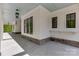 Expansive covered patio with white siding, black window frames, and stone base at 155 Eagle Chase Ln, Troutman, NC 28166