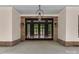 Inviting covered patio features stone accents, pendant lighting, and grand entrance doors at 155 Eagle Chase Ln, Troutman, NC 28166