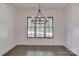 Dining room with dark hardwood floors and a modern chandelier overlooking a private outdoor space at 155 Eagle Chase Ln, Troutman, NC 28166