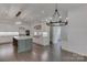 Bright, open kitchen with white cabinets, stainless steel appliances, and a large island with stone countertops at 155 Eagle Chase Ln, Troutman, NC 28166
