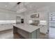 A modern kitchen featuring a large center island with stone countertops, stainless appliances and white cabinets at 155 Eagle Chase Ln, Troutman, NC 28166