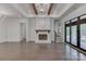 Bright, open living space with hardwood floors, fireplace, and large windows at 155 Eagle Chase Ln, Troutman, NC 28166