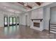 Bright, open living space with hardwood floors, fireplace, and large windows at 155 Eagle Chase Ln, Troutman, NC 28166