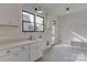 Well-lit mud room with storage cabinets, sink, and convenient bench seating at 155 Eagle Chase Ln, Troutman, NC 28166