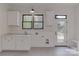 Bright mud room with tiled floor, sink, storage, and outdoor access at 155 Eagle Chase Ln, Troutman, NC 28166