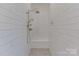 Spa-like shower featuring white subway tile, a built-in bench, and a dual shower head system at 155 Eagle Chase Ln, Troutman, NC 28166