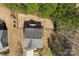 Aerial view shows backyard with patio, fire pit, fence and mature trees at 15916 Foreleigh Rd, Huntersville, NC 28078