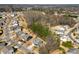 Aerial shot of neighborhood with mature trees; some homes have pools and fences at 15916 Foreleigh Rd, Huntersville, NC 28078