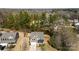 An aerial view shows this two-story home, a manicured front lawn and established landscaping with mature trees at 15916 Foreleigh Rd, Huntersville, NC 28078