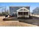 A beautiful backyard with a fire pit, outdoor furniture, and a covered patio at 15916 Foreleigh Rd, Huntersville, NC 28078