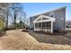 A large backyard boasts a screened in porch, stone fire pit, and black fence at 15916 Foreleigh Rd, Huntersville, NC 28078