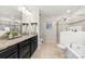 Spacious bathroom with a tub, frameless shower, double vanity and tile flooring at 15916 Foreleigh Rd, Huntersville, NC 28078