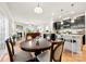 Open-concept layout with a dining area that seamlessly flows into the living room and kitchen at 15916 Foreleigh Rd, Huntersville, NC 28078