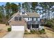 Beautiful two-story home features a manicured lawn, brick accents, and a cozy front porch sitting area at 15916 Foreleigh Rd, Huntersville, NC 28078