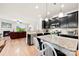 Bright kitchen with stainless appliances, granite countertops and an island with bar seating at 15916 Foreleigh Rd, Huntersville, NC 28078