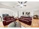 Spacious living room with wood floors, a ceiling fan, and comfortable seating at 15916 Foreleigh Rd, Huntersville, NC 28078