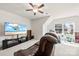 Cozy living room with a large TV, ceiling fan and comfortable leather seating at 15916 Foreleigh Rd, Huntersville, NC 28078