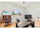 Bright office space with wood floors, built-in shelving, and a large desk for productive work from home at 15916 Foreleigh Rd, Huntersville, NC 28078