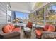 Cozy sunroom with wicker furniture set, screened windows and tile flooring at 15916 Foreleigh Rd, Huntersville, NC 28078