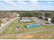 Neighborhood aerial view showcases a community pool, tennis courts, and playground on a sunny day at 160 Belfry Loop, Mooresville, NC 28117
