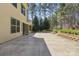 Large concrete back patio extends to spacious backyard lined with trees and landscaping at 160 Belfry Loop, Mooresville, NC 28117