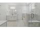 Pristine bathroom with a glass-enclosed shower, soaking tub, and sleek white vanity at 160 Belfry Loop, Mooresville, NC 28117