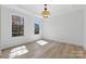Bright, airy bedroom with large windows and wood flooring, and modern ceiling light at 160 Belfry Loop, Mooresville, NC 28117
