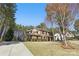 Beautiful two-story home with a long driveway and lush green lawn surrounded by tall trees at 160 Belfry Loop, Mooresville, NC 28117