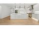 Modern kitchen with a large island, stainless steel appliances, and sleek white cabinets at 160 Belfry Loop, Mooresville, NC 28117