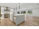 Modern kitchen with a large center island, stainless steel appliances, and hardwood floors at 160 Belfry Loop, Mooresville, NC 28117