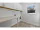 Well-lit laundry room boasts white cabinetry, countertop space, stainless steel appliances, and a bright window at 160 Belfry Loop, Mooresville, NC 28117