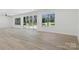 Bright living room featuring large windows and a sliding glass door leading to the backyard at 160 Belfry Loop, Mooresville, NC 28117