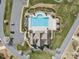 Aerial view of a community pool with an adjacent clubhouse and parking area in a residential neighborhood at 160 Belfry Loop, Mooresville, NC 28117