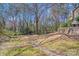 Large backyard with mature trees, providing shade and a natural setting at 1606 Sharon W Rd, Charlotte, NC 28210