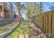 Inviting backyard features mature trees and a privacy fence creating a serene outdoor space at 1606 Sharon W Rd, Charlotte, NC 28210