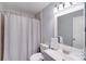 Well-lit bathroom featuring a shower with bathtub, modern fixtures, and a sleek vanity with a decorative mirror at 1606 Sharon W Rd, Charlotte, NC 28210
