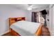 Well-lit bedroom with a ceiling fan, wood floors, and sliding glass doors leading to a private balcony at 1606 Sharon W Rd, Charlotte, NC 28210