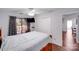 Cozy bedroom features hardwood floors, a ceiling fan, sliding glass doors leading to a private patio, and lots of storage at 1606 Sharon W Rd, Charlotte, NC 28210