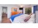 Bright bedroom features hardwood floors, a ceiling fan, sliding glass doors to a balcony, and custom built-in bed frame at 1606 Sharon W Rd, Charlotte, NC 28210