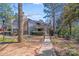 Charming condo exterior with brick accents, a front patio, and mature trees on a sunny day at 1606 Sharon W Rd, Charlotte, NC 28210