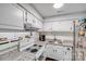 Bright kitchen boasts granite countertops, white cabinets, and stainless steel sink at 1606 Sharon W Rd, Charlotte, NC 28210