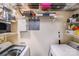 Well-organized laundry room featuring front-loading washer and dryer, with overhead shelving and storage solutions at 1606 Sharon W Rd, Charlotte, NC 28210